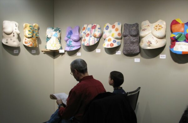 Boys sketching the sculptures at the Beautiful Women Project Exhibit